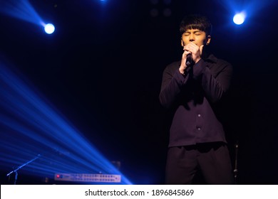 singer man posing and singing on stage