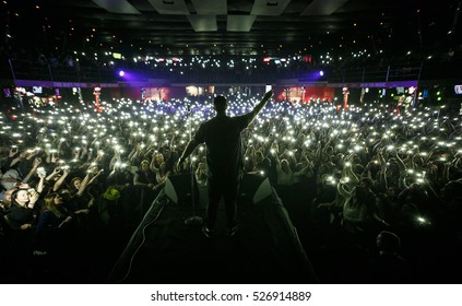 Singer On Stage. Popular Music Concert Background. Concerts Crowd Waving Hands With Phones Lights, View From Stage. Curated Stock Collection With Editorial Images. EUROPE-3 NOVEMBER,2016