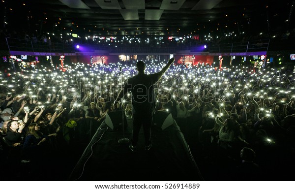 Singer on\
stage. Popular music concert background. Concerts crowd waving\
hands with phones lights, view from stage. Curated stock collection\
with editorial images. EUROPE-3\
NOVEMBER,2016