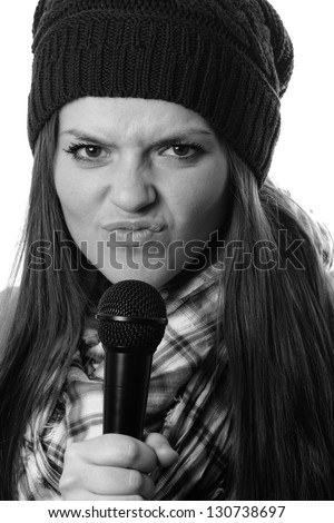 Singer - This is a black and white photo of a cute young woman making a funny expression while holding a microphone. Shot on an isolated white background.