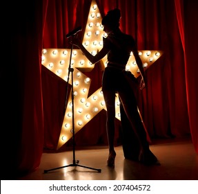 Singer Woman On Stage With Broadway Star On Background