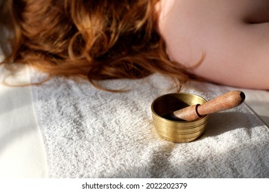 Singing Bowl And Woman At Background In Spa Salon With Sunlight. Sound Therapy And Body Care Concept. Sunlight Effect