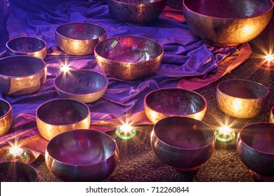 singing bowls lit by candlelight