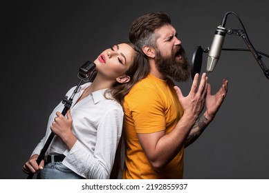 Singing Man In A Recording Studio. Expressive Couple With Microphone. Karaoke Duet Signers, Musical Vocalist.