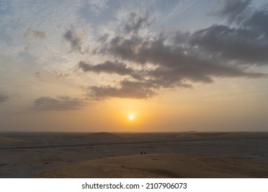 Singing Sand Dune In Qatar During Sunset.