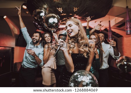 Singing Songs. Black Dress. Have Fun. Celebration. Background. Trendy Nightclub. Cheerful. Smiling Girl. Singing Songs. Handsome Men. Beautiful Girls. Friends at Karaoke Club. Karaoke Club.