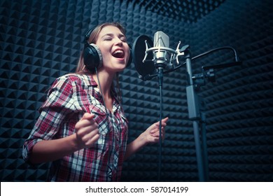 Singing woman in a recording studio