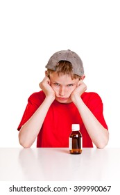 Single Angry Teenager In Red Short Sleeved Shirt And Backwards Hat With Hands On Cheeks Behind Medicine Bottle