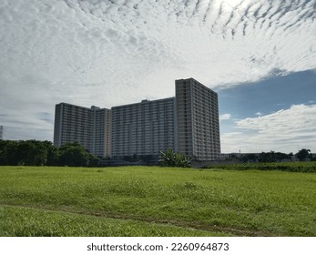 Single apartment complex in the middle of the grass field on a sunny morning day