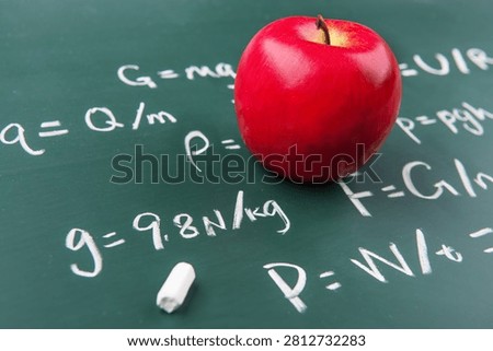 A single apple invites deep thought among physics formulas.