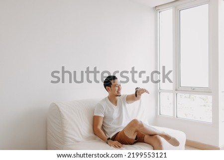 Single asian man playing with his sugarglider pet alone in his apartment. High quality photo