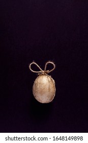 A Single Aster Egg Decorated With Crafty Paper And Ribbon On The Dark Background