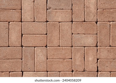 Single basketweave rectangular concrete paving stone pattern for walkway, pathway or patio. Brown paver background.