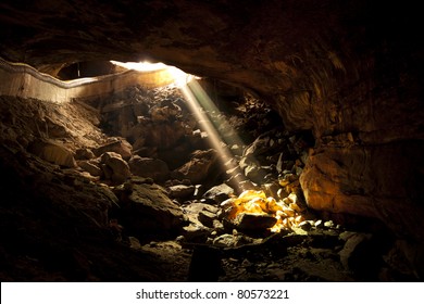 Single beam from the sun that shines into the mouth of a cave in the provinces of Thailand