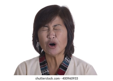 Single Beautiful Mature Asian Woman Yawning Or Yelling With Mouth Open And Eyes Shut Tightly Over White Background