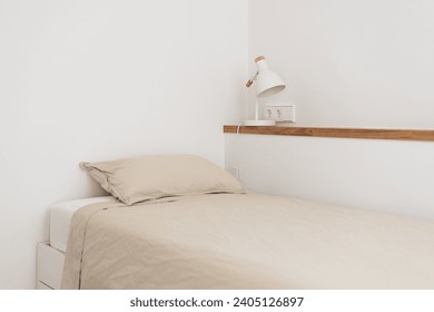 Single bed near wall shelf with night lamp in white bedroom - Powered by Shutterstock