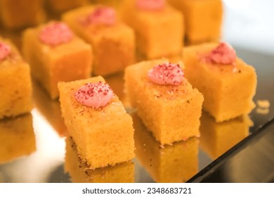 A single bite-sized or one bite small cakes on display for breakfast, lunch, brunch, dinner, and coffee break time. Concept for hotel restaurant wedding buffet - Powered by Shutterstock