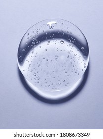 Single blob of transparent glycerin or gel. Glossy texture with tiny bubbles. 