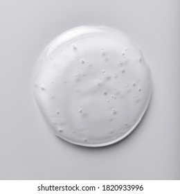 Single blob of transparent glycerin or gel. Glossy texture with tiny bubbles isolated on a white background.
