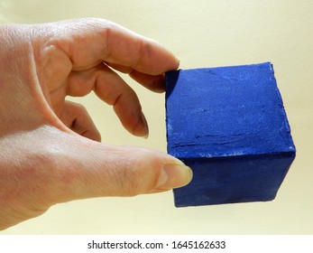 a single blue cube in the hand