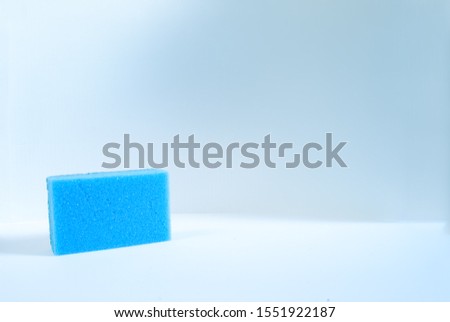 single  blue kitchen sponge islated on a white background.