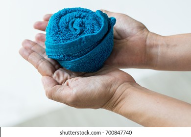 Single Blue Towel Rolled Design In Rose Flower Shape On Hand. Prepare For Guest In Luxury Hotel That Welcome From Travel. Cloth For Wiping Hands In Restaurant.