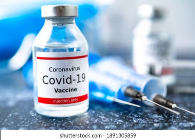 A single bottle vial of Covid-19 vaccine. Medical concept vaccination hypodermic injection treatment. Vaccine and syringe injection.
