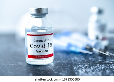 A single bottle vial of Covid-19 vaccine. Medical concept vaccination hypodermic injection treatment. Vaccine and syringe injection.