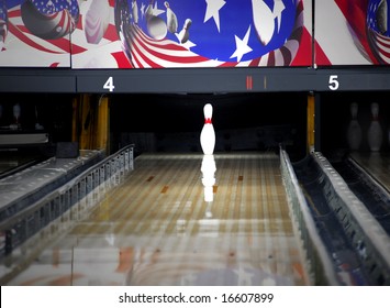 Single Bowling Pin Standing In Center Of Alley