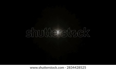 A single bright star or celestial object shines in the vast darkness of deep space, surrounded by a faint glow.
