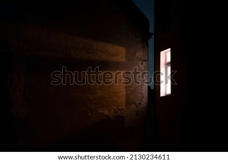A single bright window in the darkness at night. Awakened alone, Insomnia background photo