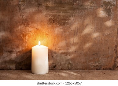 Single Candle Light On Grunge Background.still Life