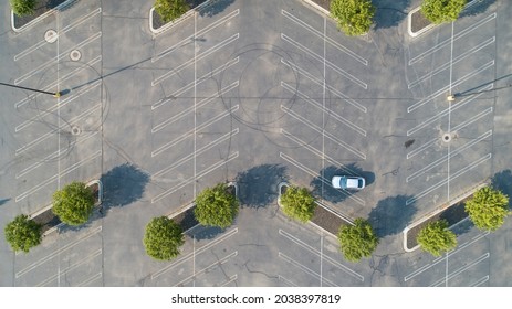 Single Car Parked Outside The Lines Of An Empty Parking Lot