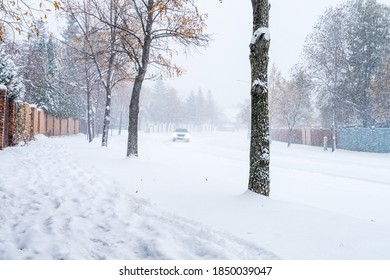 A Single Car At Snowfall At City Of Edmonton Street