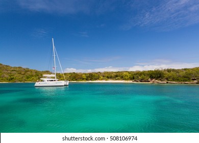A single catamaran in a quiet and calm bay in Antigua