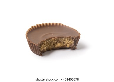 A Single Chocolate Peanut Butter Cup With A Bite Taken Out Of It, Isolated On White With Shadow