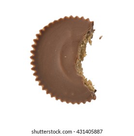 A Single Chocolate Peanut Butter Cup Overhead With A Bite Taken Out Of It, Isolated On White.