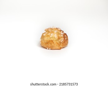 single chouquette coated with pearl sugar on white background