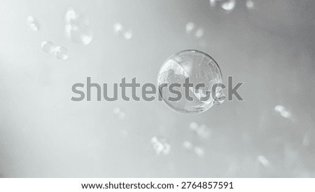 a single clear soap bubble floating in the air