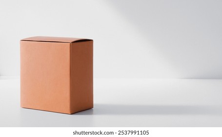 Single closed cardboard box on a plain white surface. Premium packaging box mockup for displaying a marketing advertisement for a product.