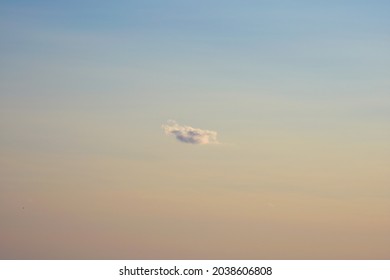 A Single Cloud Against The Sunset Sky.