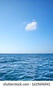 Single Cloud Over The Ocean On A Sunny Day.