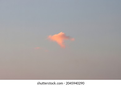 A Single Cloud In The Sky During Sunset. 