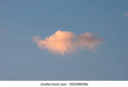 A Single Cloud In The Sky During Sunset. 