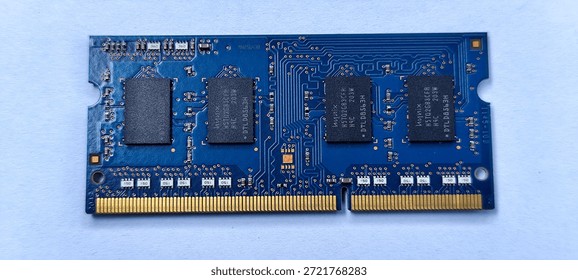 A single computer RAM module, also known as Random Access Memory, is shown in a close-up view against a plain light blue background.