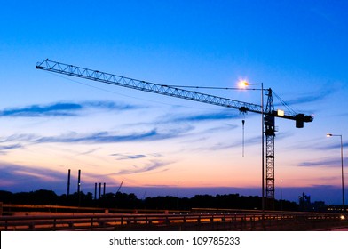 Single Crane At Night On Construction Site