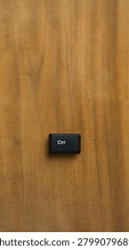 Single Ctrl Keyboard Key On Wooden Background With Copy Space