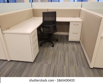 Single Cubicle In An Office Space, Empty Desk With Cabinets And Desk Chair