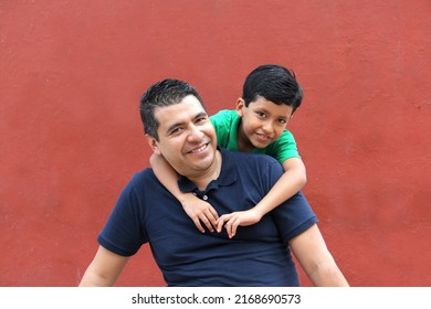 Single dad and dark-haired Latino son play and have fun together spending quality family time on Father's Day celebrating victory with hugs and kisses
 - Shutterstock ID 2168690573