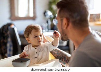 Single dad feeding his baby 
 - Powered by Shutterstock